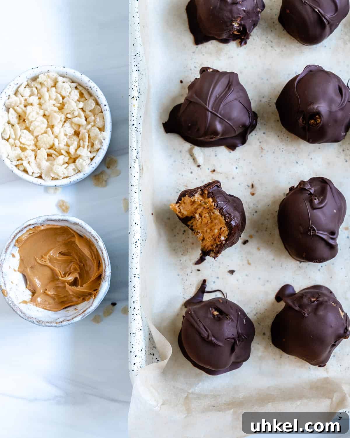 Vegan No-Bake Chocolate Peanut Butter Krispie Balls 2 several completed Peanut Butter Bon Bons with one with a bite taken out of it