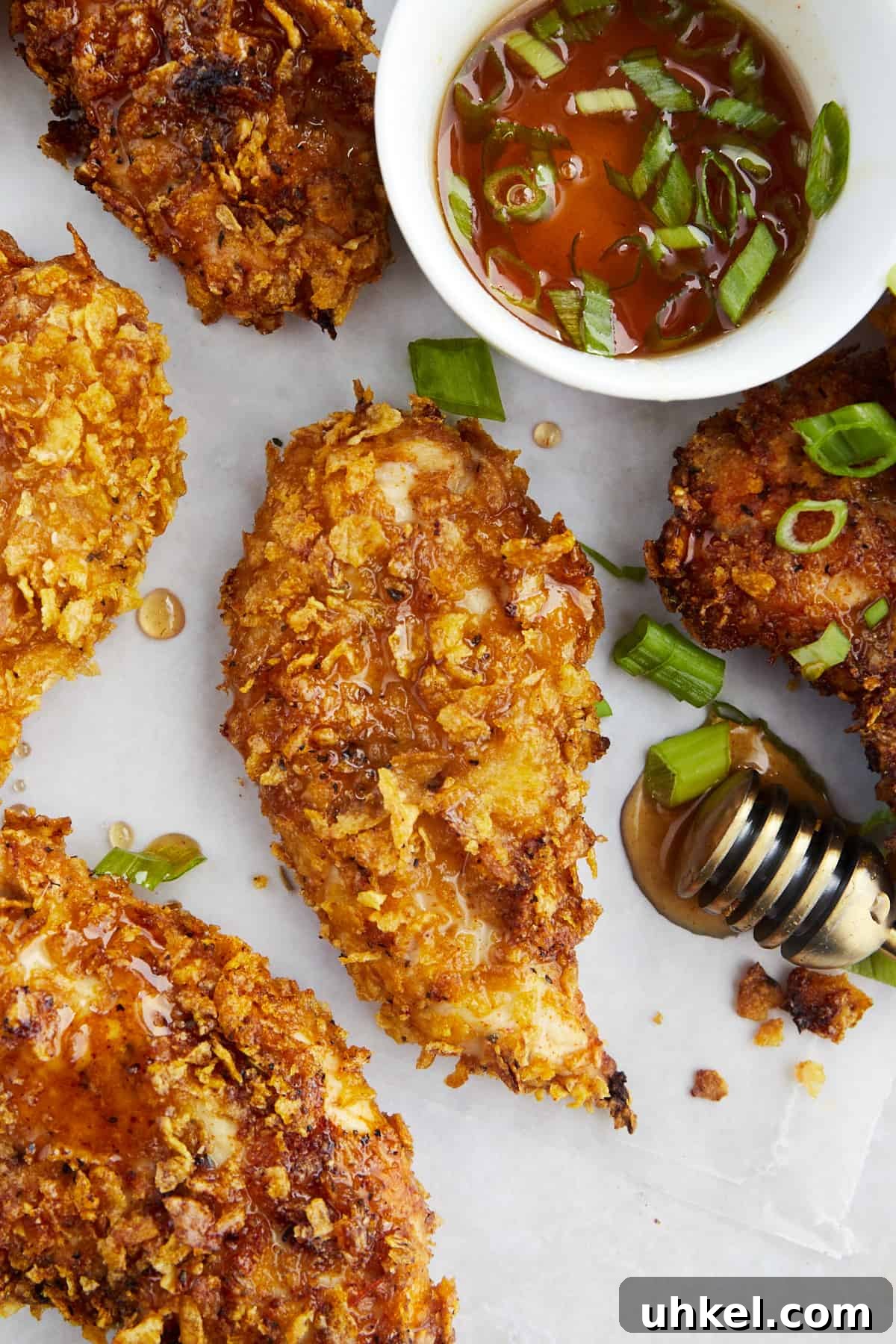 Baked cornflake chicken tenders with a side of hot honey.