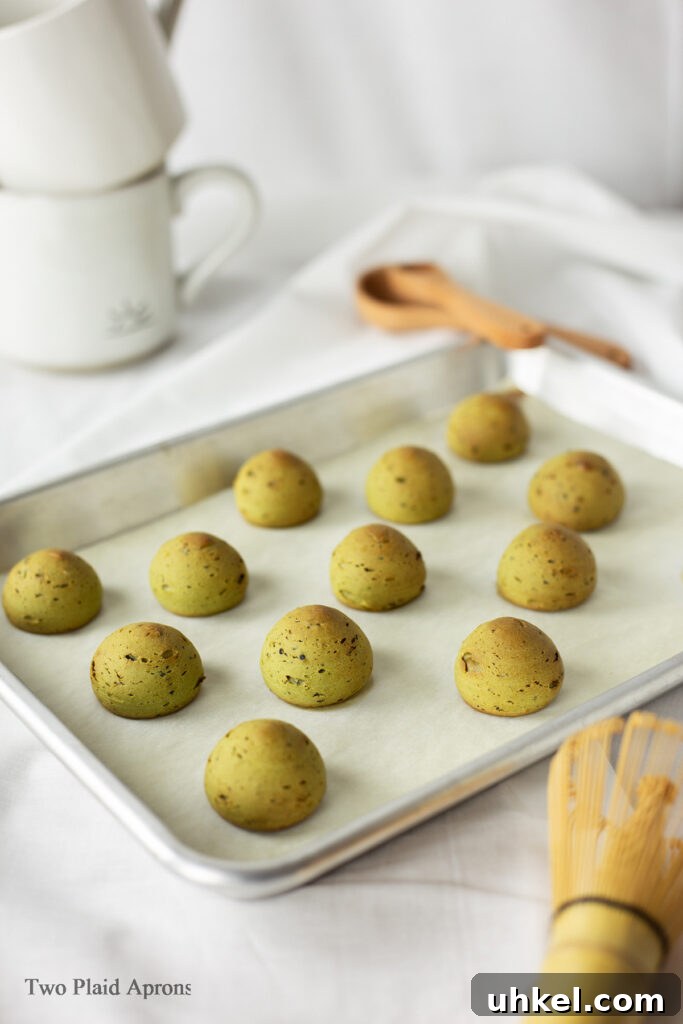 A tray of baked matcha mochi breads.