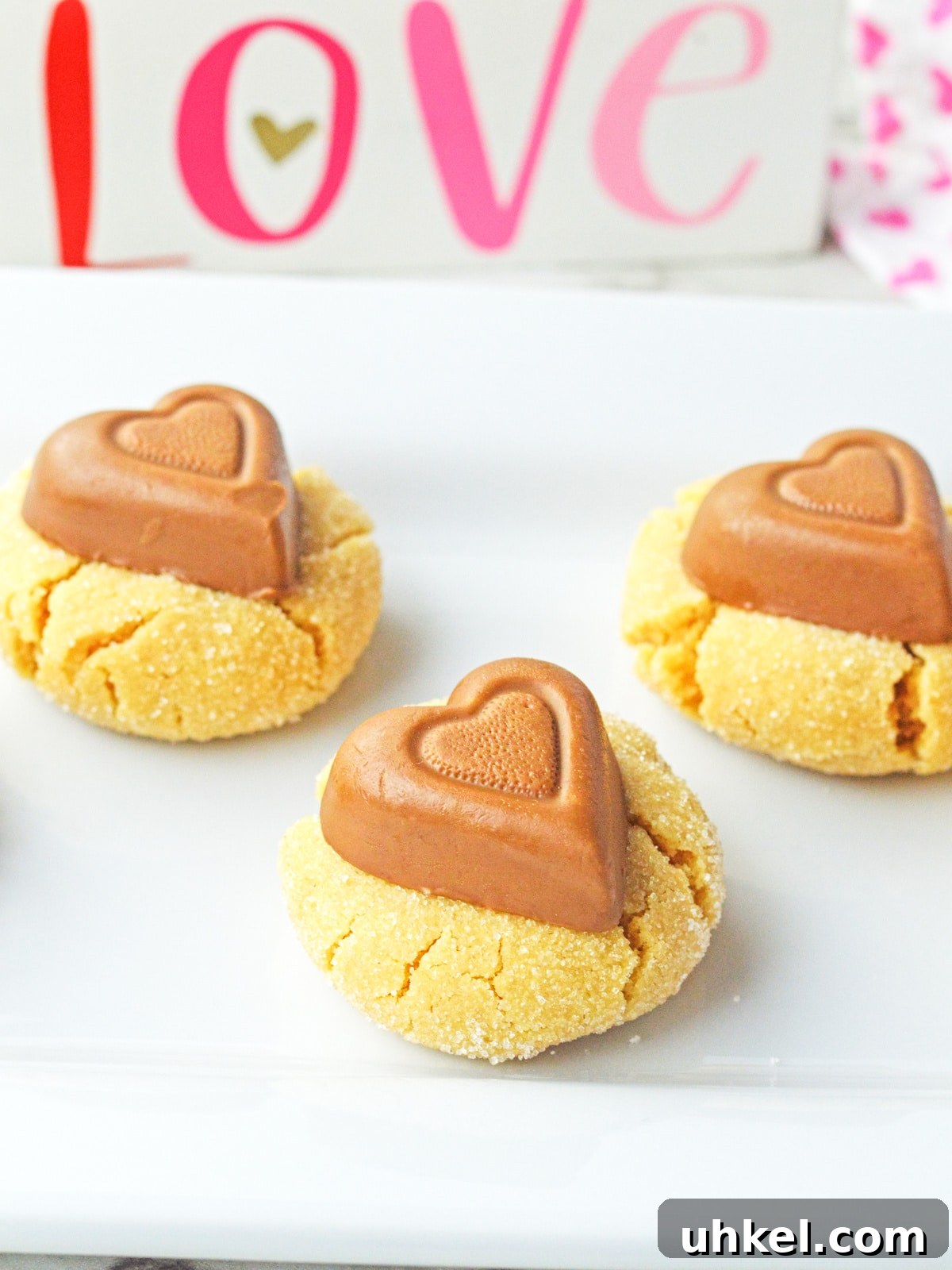 Peanut Butter Blossom Cookies for a Valentine’s Day Treat 2 Peanut Butter Heart Blossoms on a plate