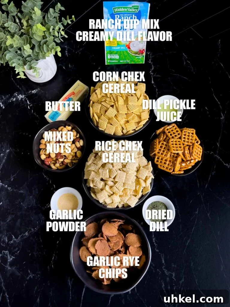 Tangy Dill Pickle Chex Mix Snack Recipe for Parties 3 Dill pickle Chex mix ingredients on a dark surface.