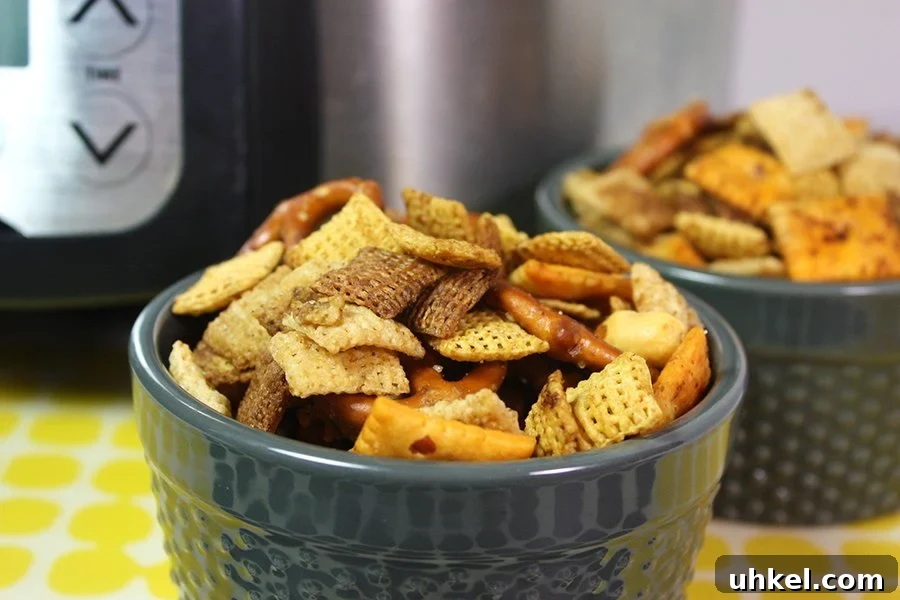 Tangy Dill Pickle Chex Mix Snack Recipe for Parties 9 Slow Cooker Chex Mix in a blue serving bowl.