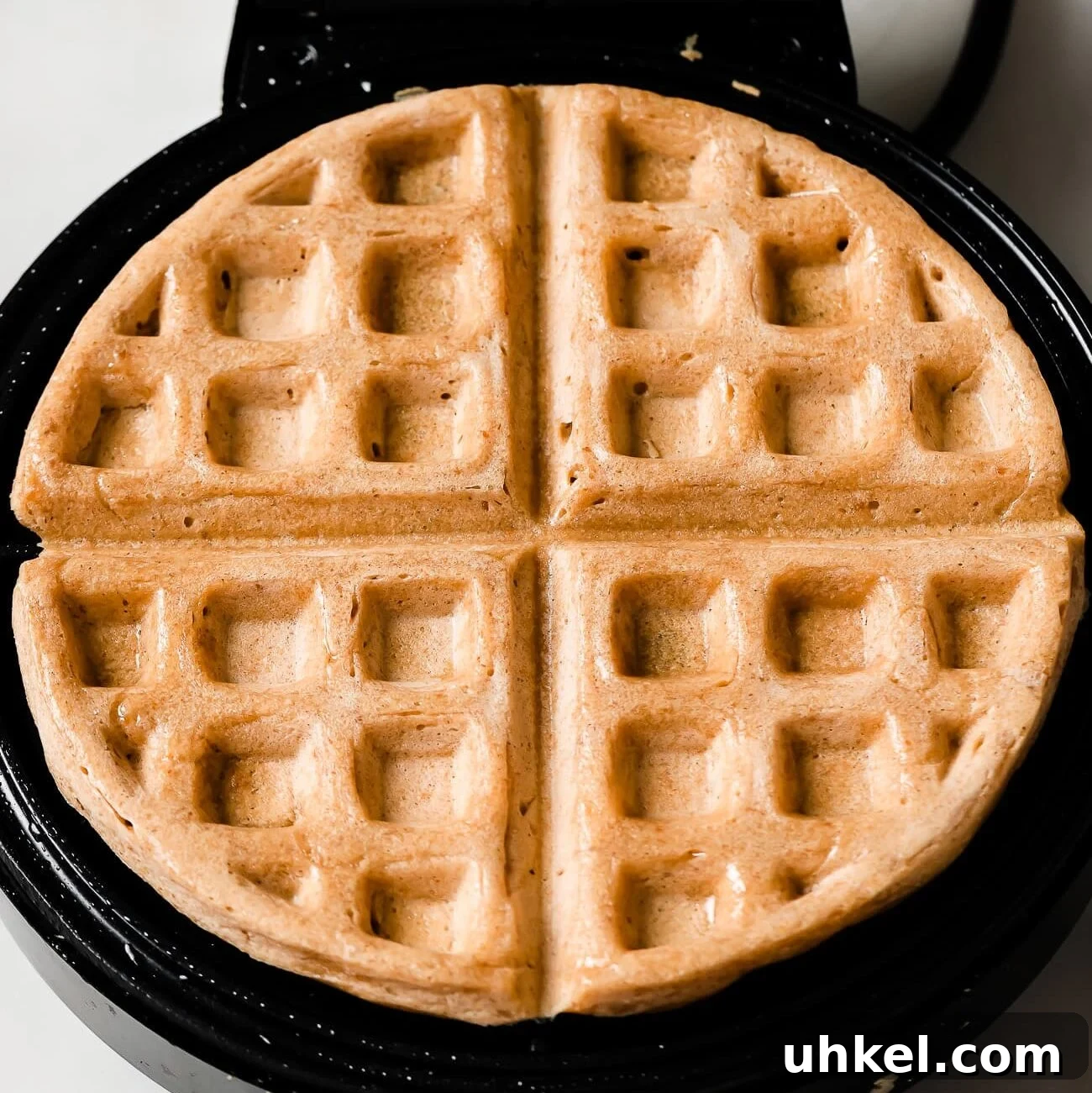 Crispy Peanut Butter Waffles with Maple Syrup 12 crispy waffles in a waffle machine.