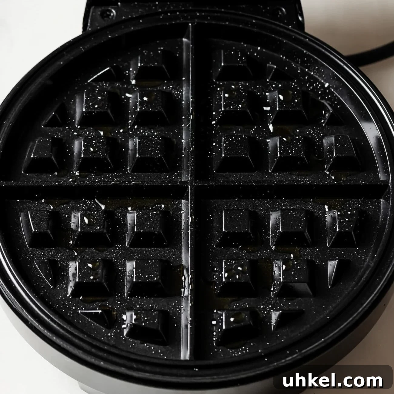 Crispy Peanut Butter Waffles with Maple Syrup 5 waffle iron open with cooking oil.