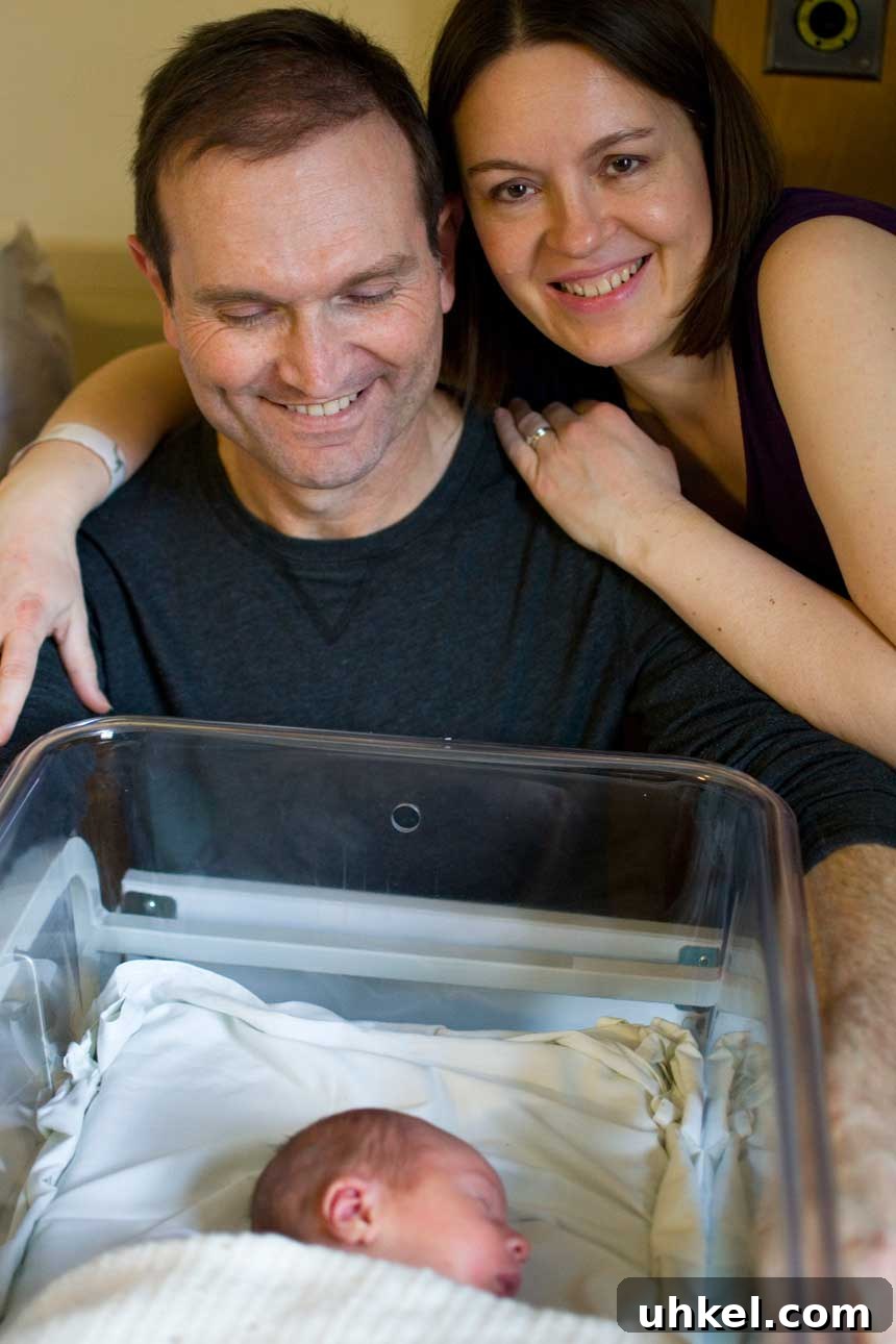 Meet Benjamin James: Award-Winning Photographer & Creative Director 2 A couple with their arms around each other watching over a newborn baby.