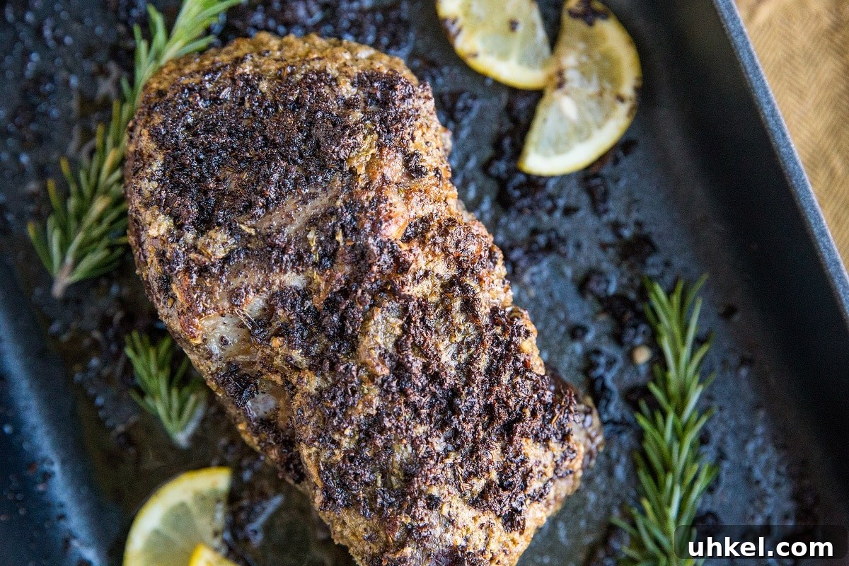 Garlic and Herb Beef Roast Recipe for Juicy Oven-Roasted Beef 7 Finished beef sitting in a roasting pan after baking