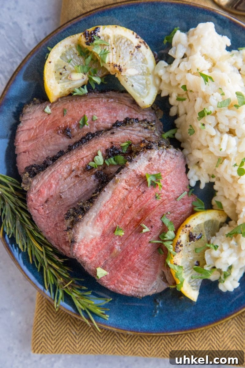 Garlic and Herb Beef Roast Recipe for Juicy Oven-Roasted Beef 8 Slices of beef on a plate with risotto
