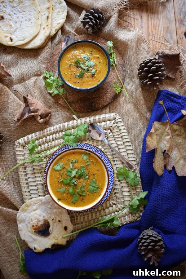 Carrot and Coriander Soup Recipe for Vibrant Flavor and Comfort 4 Table setting view of two bowls of soup.