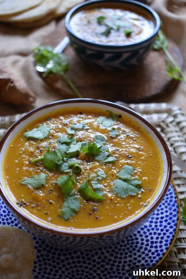 Carrot and Coriander Soup Recipe for Vibrant Flavor and Comfort 5 Soup in a bowl with fresh herbs on top.