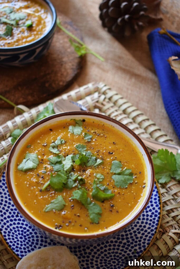 Carrot and Coriander Soup Recipe for Vibrant Flavor and Comfort 6 Carrot and Coriander Soup in a bowl on a placemat.