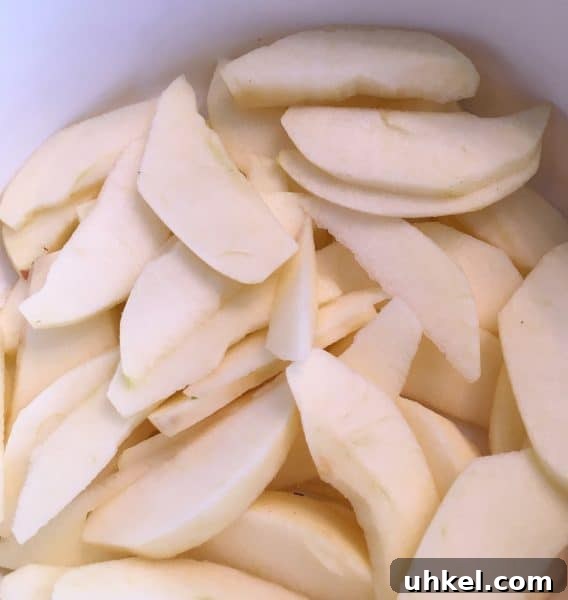 Apple Pecan Cobbler Recipe: Warm Spiced Filling with Crisp Topping 4 Apples sliced and in a baking dish