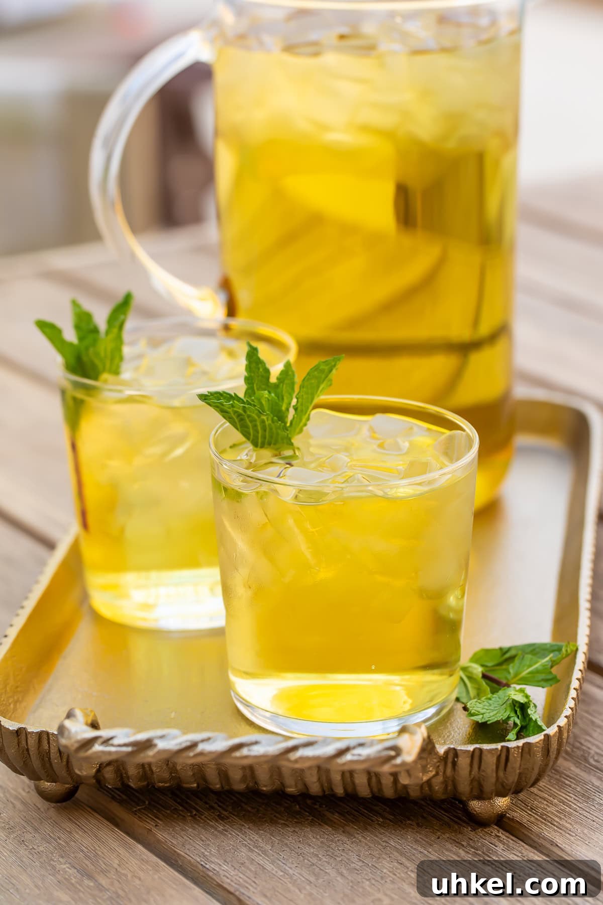 How to Make Cold-Brew Green Tea at Home: Smooth, Refreshing Iced Tea 3 Two glasses of cold brew green tea in front of a pitcher on a table.