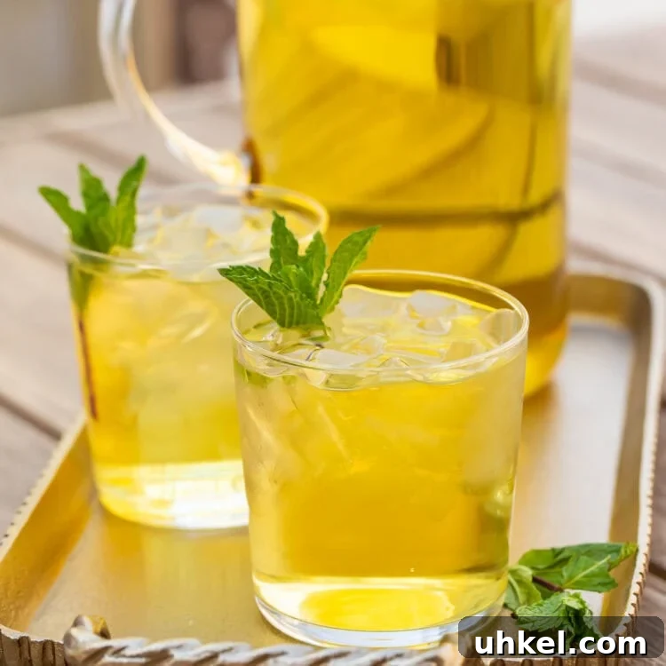 How to Make Cold-Brew Green Tea at Home: Smooth, Refreshing Iced Tea 5 Two glasses of cold brew green tea in front of a pitcher on a table.