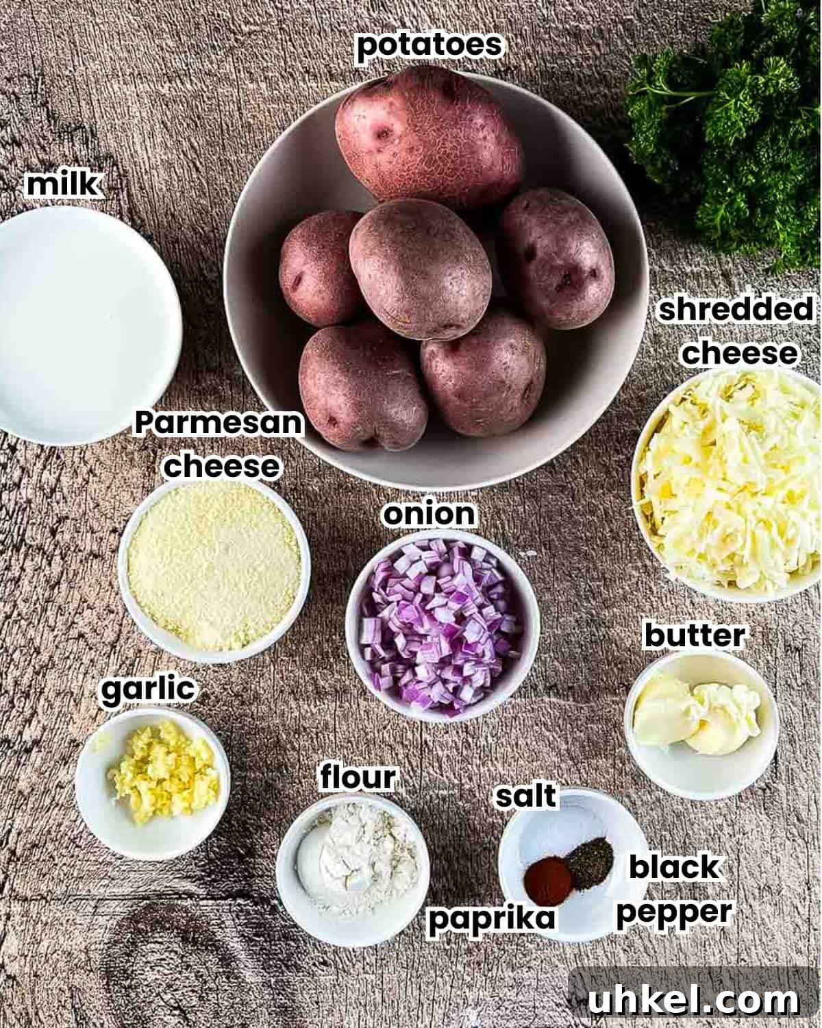 Crispy Cheesy Scalloped Potatoes Made in the Air Fryer 3 Ingredients for air fryer scalloped potatoes measured out, labeled, and placed on a wooden table.