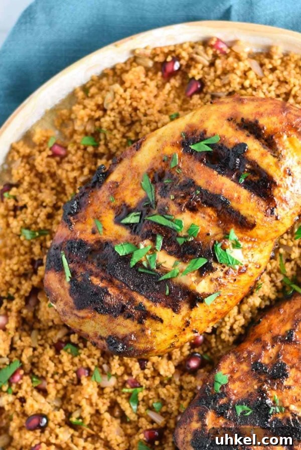 Juicy Mexican-Style Grilled Chicken with Zesty Marinade 11 Grilled chicken breasts on a bed of couscous.