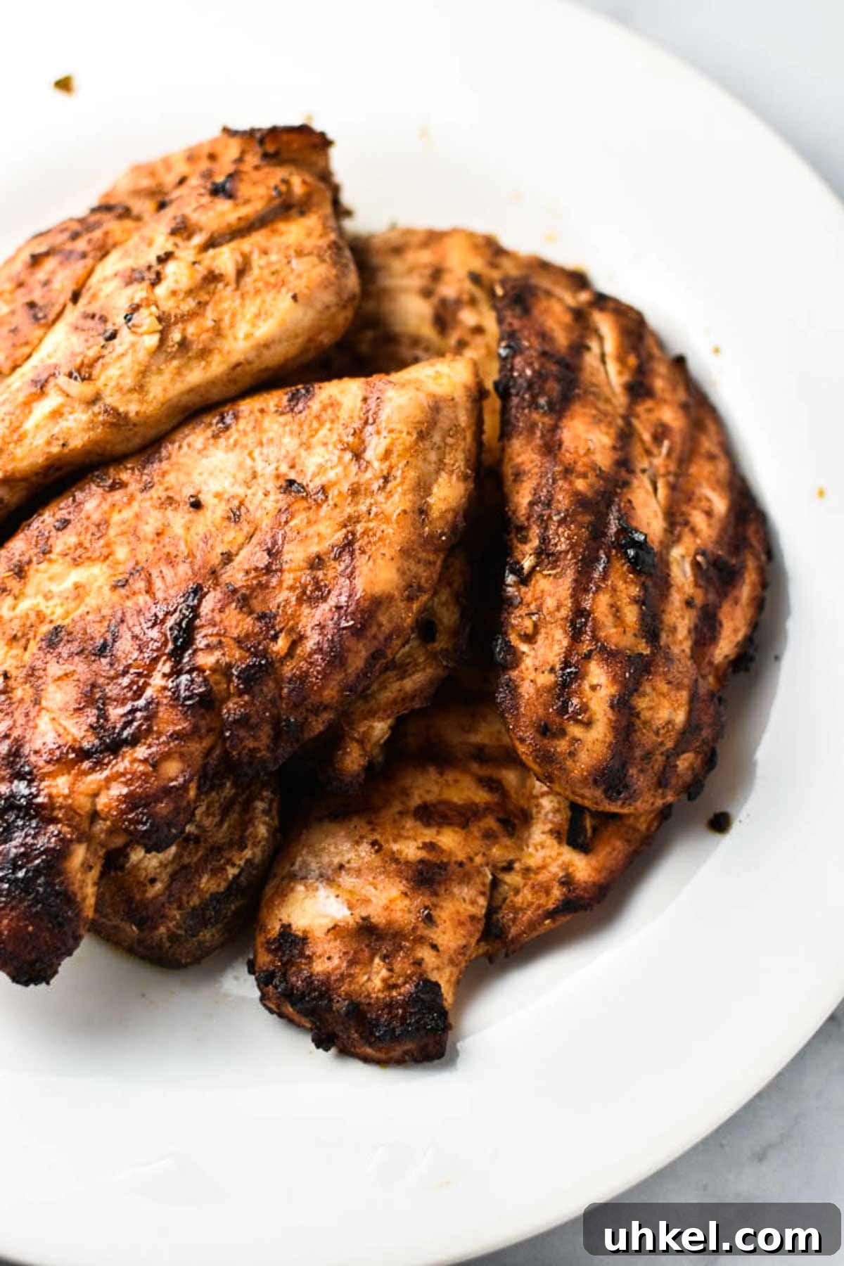 Juicy Mexican-Style Grilled Chicken with Zesty Marinade 10 Grilled chicken on a white plate