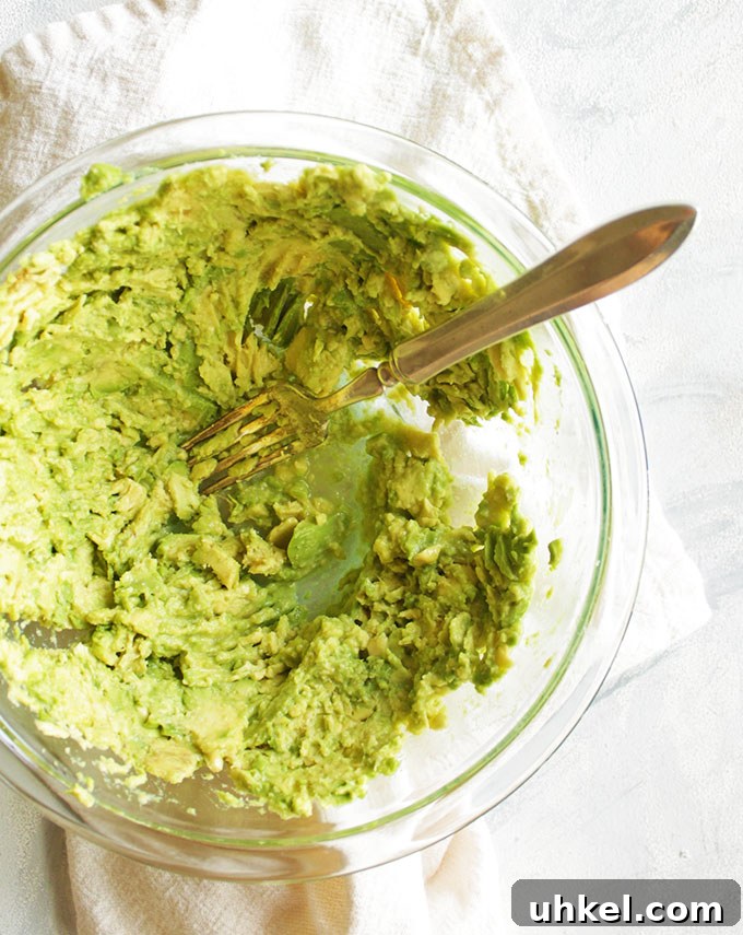 Ultimate Creamy Guacamole Recipe for Perfect Party Dip 5 The BEST Ever Guacamole - Guacamole is a simple Mexican dip made with mashed avocados, lime juice, cilantro, garlic, and jalapenos. Serve it with tortilla chips for dipping! Also great as an appetizer or side dish to any Mexican food. Bonus points if you serve it with a margarita! One of our favorite/most made recipes! So YUM! #guacamole #avocados #glutenfree #Mexicanfood #vegan #vegetarian | robustrecipes.com