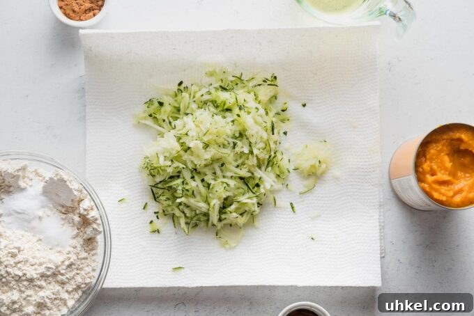 Moist Pumpkin Zucchini Muffins with Warm Spices 5 Grated zucchini resting on paper towels.