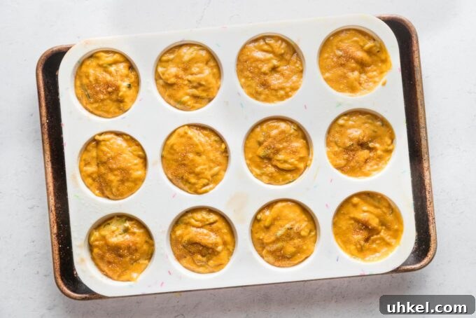 Moist Pumpkin Zucchini Muffins with Warm Spices 9 Pumpkin zucchini muffin batter portioned among muffin wells and ready to bake.