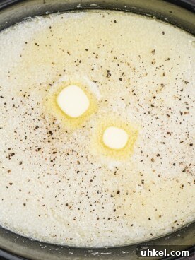 Slow-Cooker Creamy Grits Recipe for Perfectly Smooth Breakfast 7 close up of grits with butter and black pepper