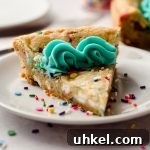 a slice of funfetti sugar cookie cake on a plate