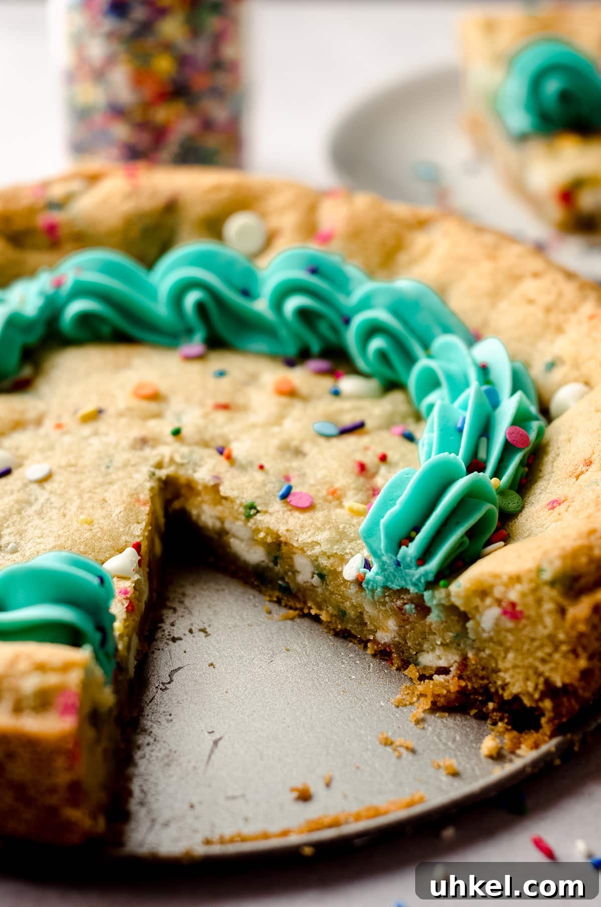 funfetti sugar cookie cake with a slice taken out of it