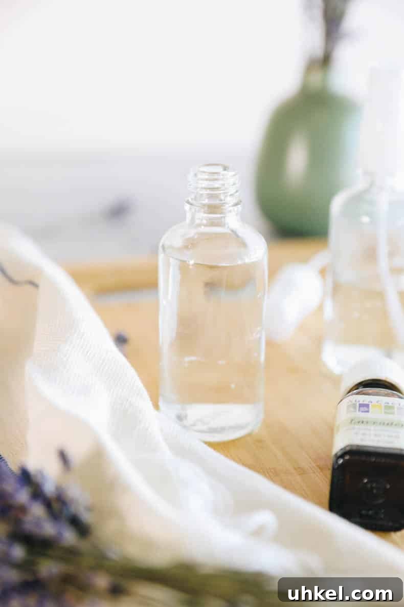 Make Lavender Spray at Home: Simple DIY Room and Linen Mist 5 distilled water and witch hazel in a clear glass bottle