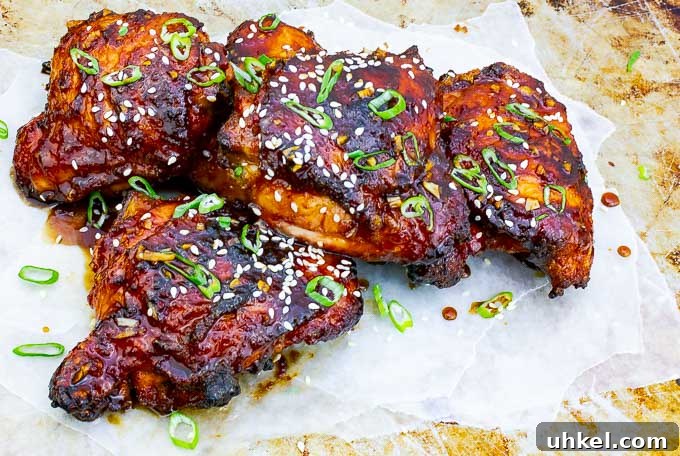 Sticky Asian-Style Grilled Chicken Thighs with Sweet Glaze 3 four Sticky Asian Grilled Chicken Thighs on white and metal background