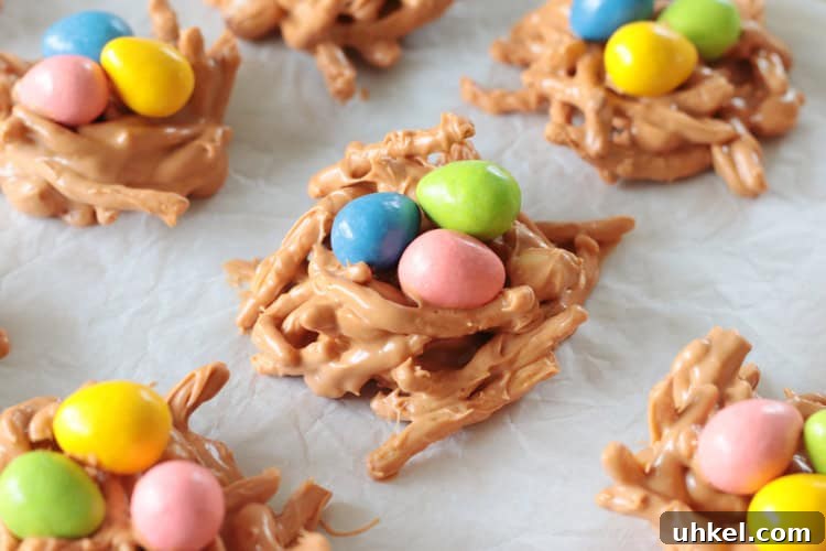 Butterscotch Haystack Cookies | Bird’s Nest Cookie Recipe 8 birds nest cookies with candy on cookie sheet