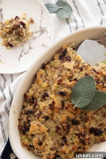 old fashioned cornbread dressing in casserole dish with a slice on a plate on the side