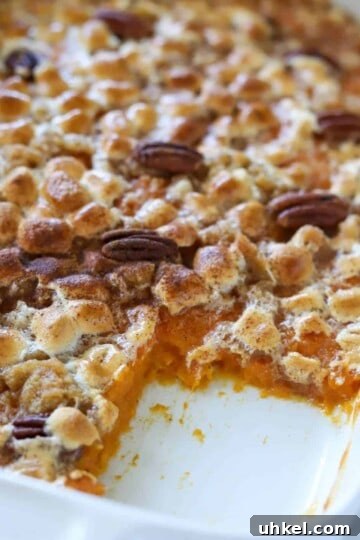 Sweet potato casserole in dish with one slice missing.