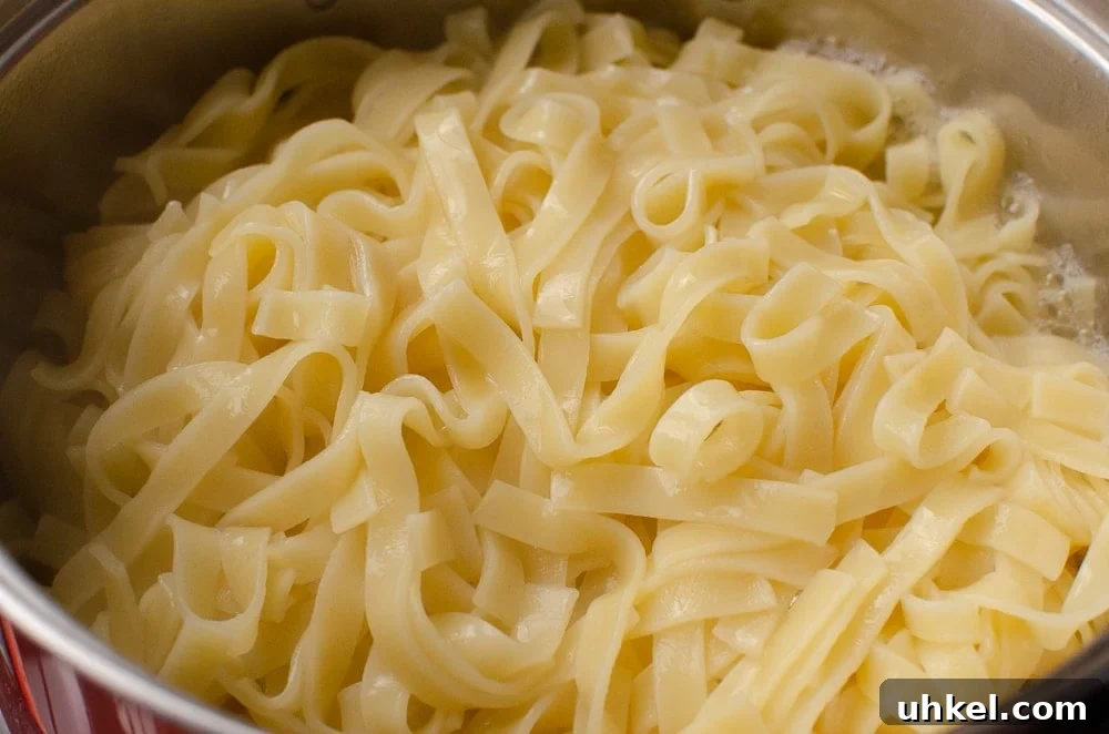 Crab Tagliatelle with Shredded Crab and Lemon Herb Sauce 3 Cooked Tagliatelle in a silver pot