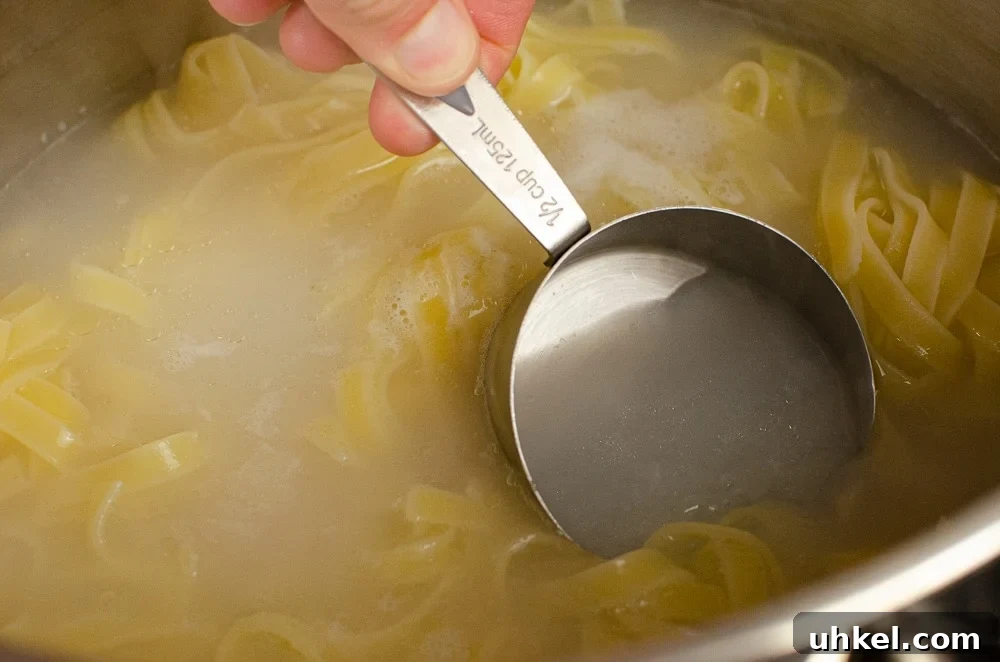Crab Tagliatelle with Shredded Crab and Lemon Herb Sauce 4 Collecting ½ cup of water from the pasta which is cooking in a silver pot
