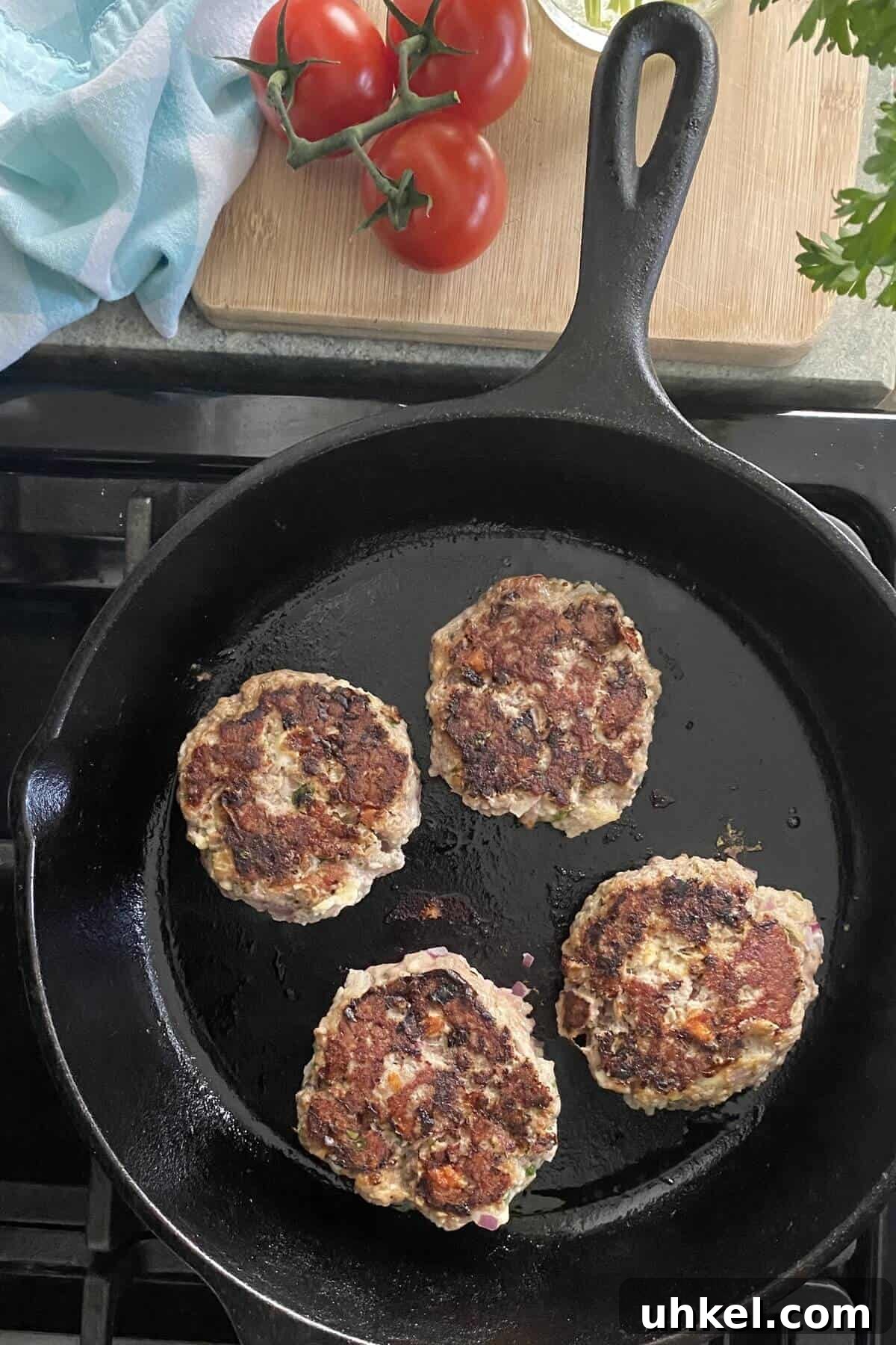 Mini Greek Turkey Sliders with Cucumber Tzatziki 7 cooking Greek turkey burgers in a cast iron skillet.