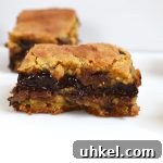 Chocolate Fudge Stuffed Cookie Bars are soft and gooey cookie bars with a quick and easy chocolate fudge running through the middle.