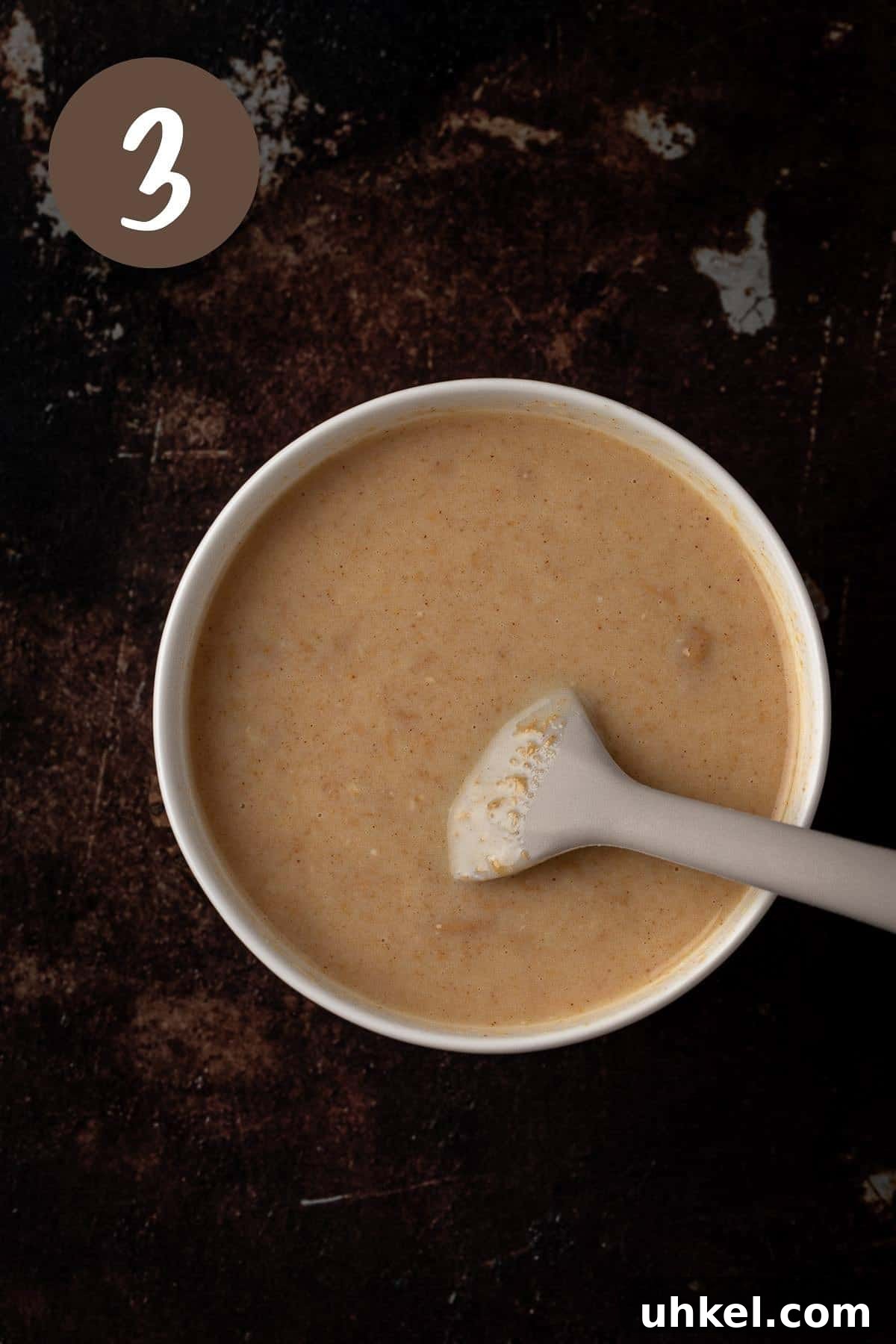 Decadent Peanut Butter Ganache Recipe for Cakes and Desserts 6 Process photo showing a bowl of melted, smooth ganache.