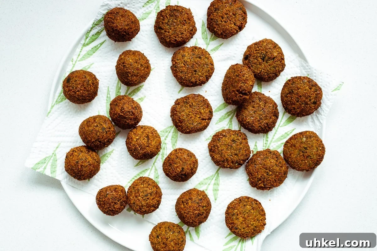 Crispy Authentic Middle Eastern Falafel Recipe 11 Crispy fried falafel on kitchen paper viewed from above.