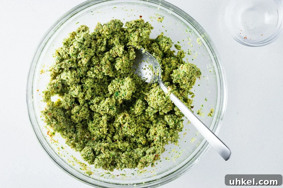 Crispy Authentic Middle Eastern Falafel Recipe 8 Green falafel mixture of soaked dried chickpeas and fresh herbs in a large mixing bowl.
