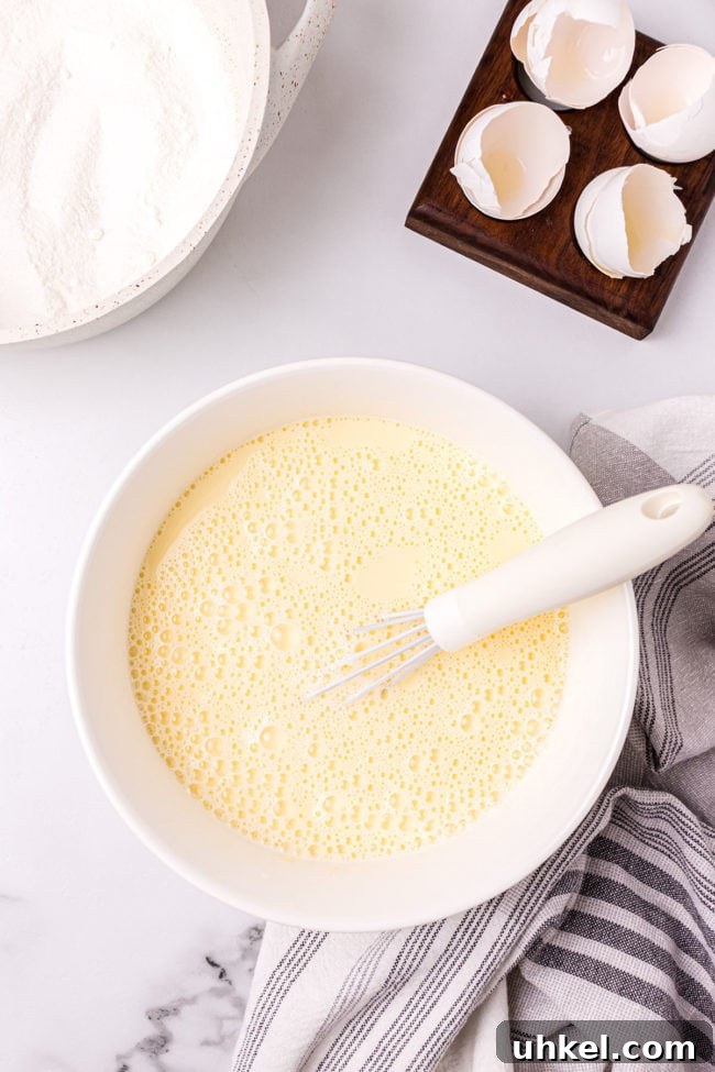 making custard pie filling in a bowl with a whisk