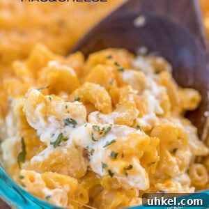 Decadent Million-Dollar Macaroni and Cheese Recipe 2 scooping mac & cheese from baking dish