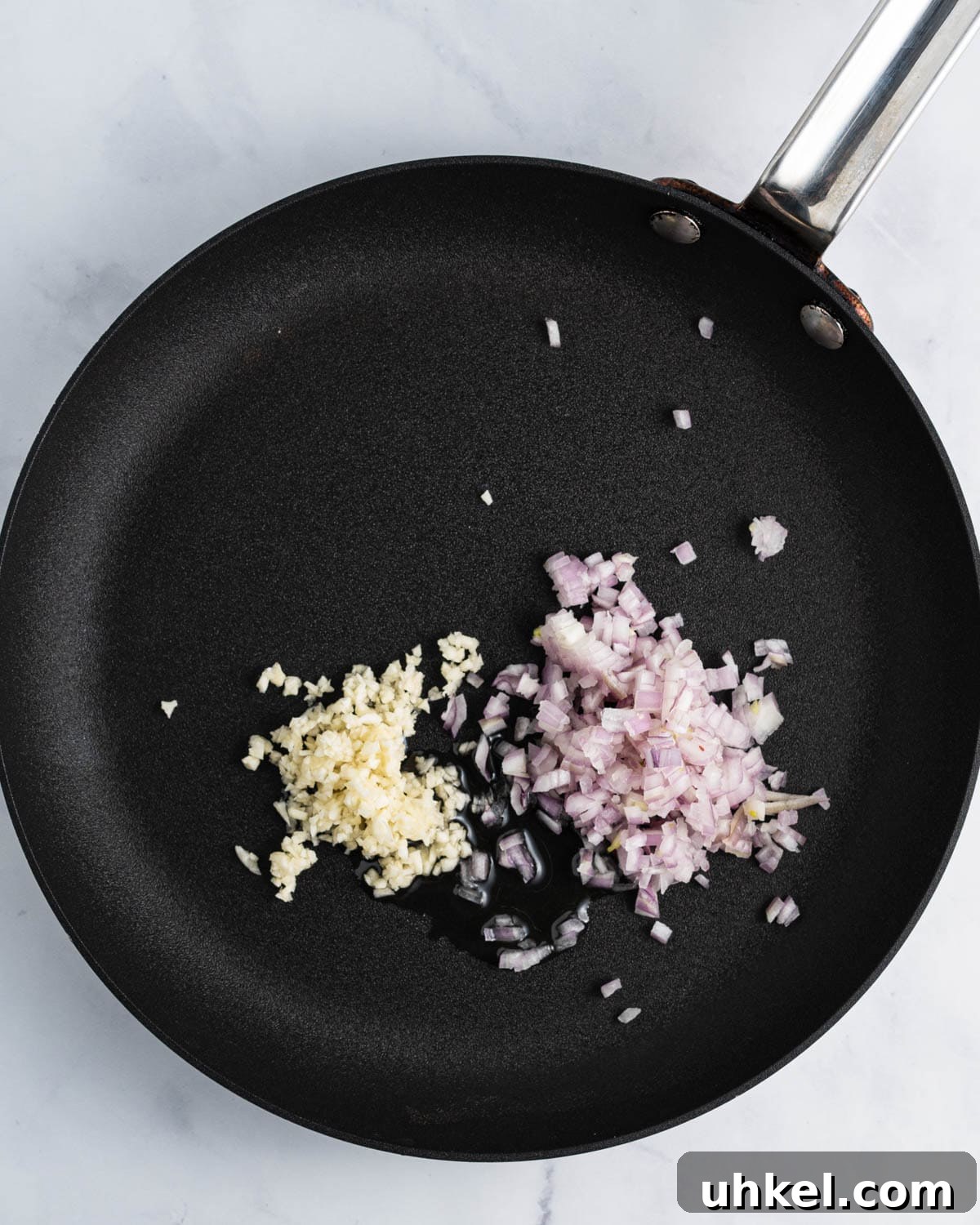 Sautéing shallots and garlic in oil.