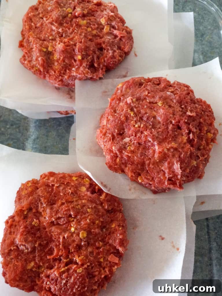 Amish-Style Grilled Burgers Recipe for Juicy Backyard BBQ 5 hamburgers with parchment paper between them