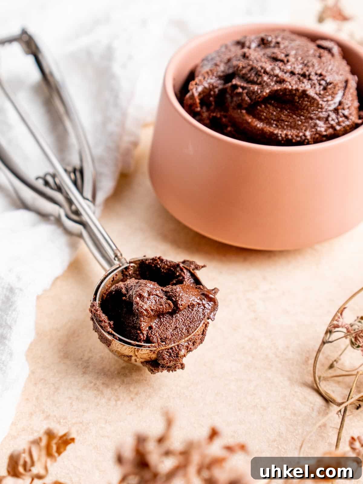 Safe-to-Eat Brownie Batter Recipe for Snacking and Desserts 8 close up of a cookie scoop with brownie batter in it