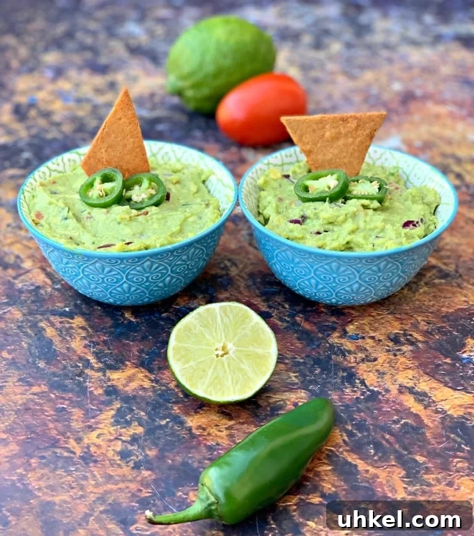 Quick Homemade Guacamole Recipe Ready in Minutes 2 keto guacamole with low carb keto chips in blue bowls with fresh vegetables