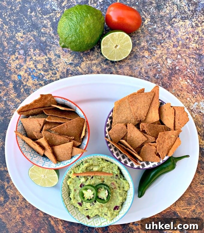 Quick Homemade Guacamole Recipe Ready in Minutes 6 keto tortilla chips in bowls on a plate with guacamole and vegetables