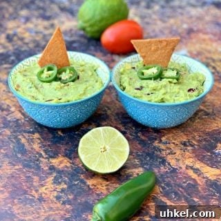 Quick Homemade Guacamole Recipe Ready in Minutes 8 keto guacamole with low carb keto chips in blue bowls with fresh vegetables