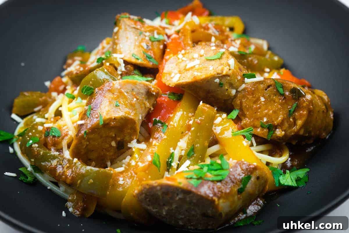 19 Budget-Friendly Dinners That Cut Your Grocery Bill (Delicious!) 2 Slow cooker sausage and peppers garnished with grated cheese and chopped parsley.