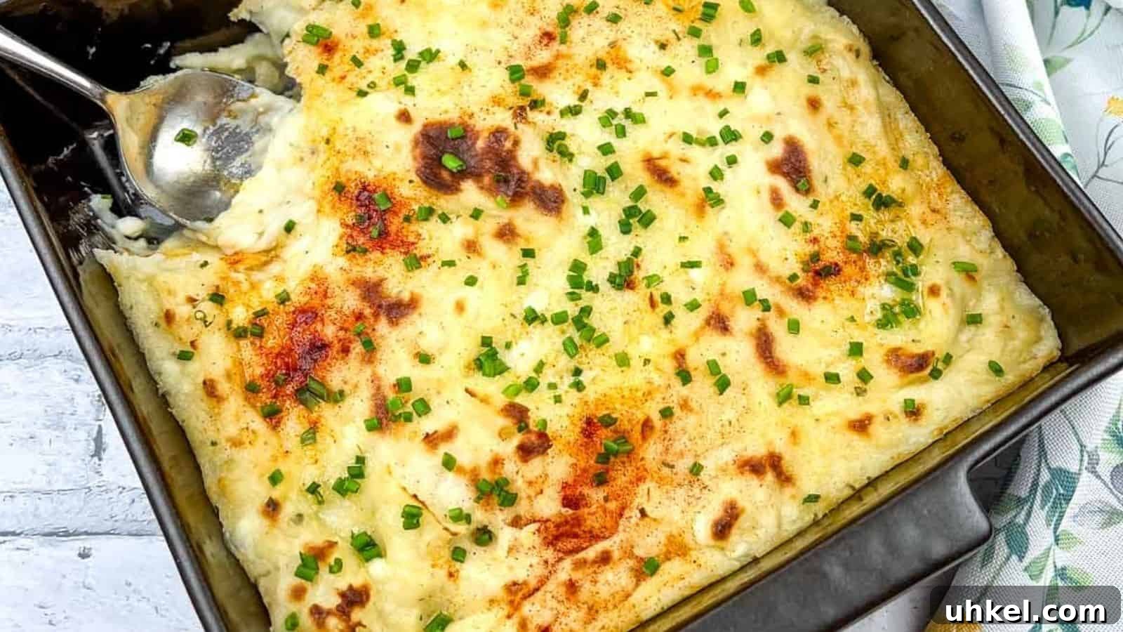 19 Budget-Friendly Dinners That Cut Your Grocery Bill (Delicious!) 17 A close-up of Grandma's Mashed Potato Casserole with a serving spoon in the dish.