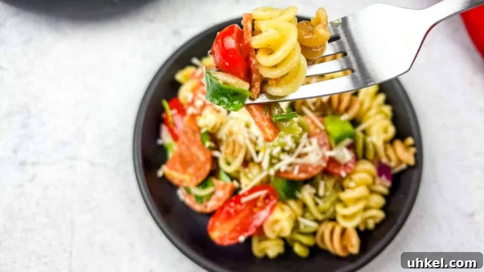19 Budget-Friendly Dinners That Cut Your Grocery Bill (Delicious!) 8 A fork with pizza pasta salad in a bowl.
