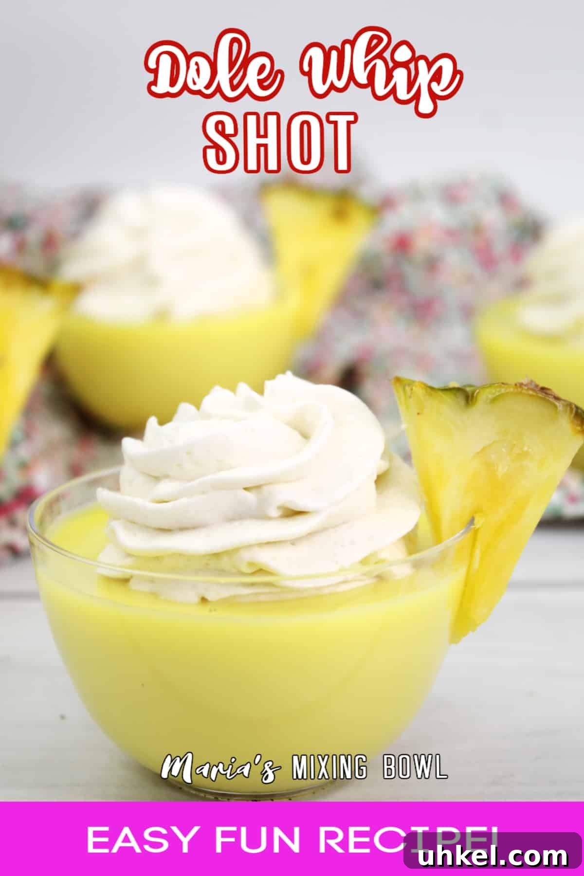 dole whip shot in a small glass bowl garnished with a slice of pineapple